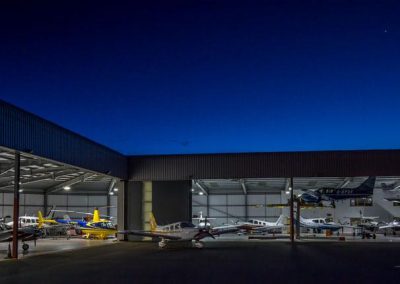 Image of FLY ASG hangar at night.